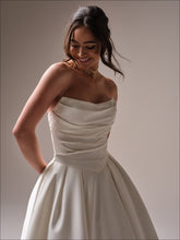 Load image into Gallery viewer, Close-up of Maureen gown bodice showing ruched satin detail and elegant cat-eye neckline – Aurelle Bridal
